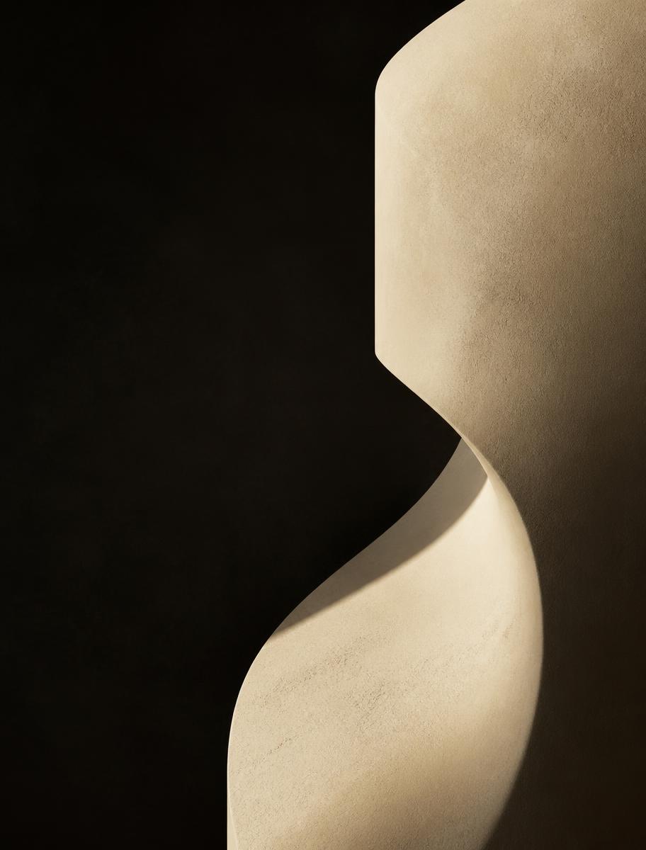 Curved plaster sculpture in raking sunlight